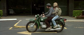 Movie still from “Garden State” (2004), directed by Zach Braff – A man and a woman riding a motorcycle down a street; Wide shot, Low angle