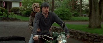 Movie still from “Garden State” (2004), directed by Zach Braff – A man and a woman riding a motorcycle; Medium shot, Over the shoulder angle