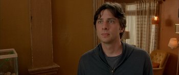 Movie still from “Garden State” (2004), directed by Zach Braff – A young man is standing in front of a brown wall; Close Up shot, Over the shoulder angle