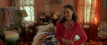Movie still from “Garden State” (2004), directed by Zach Braff – A woman standing in front of a bed in a room; Medium shot, Over the shoulder angle