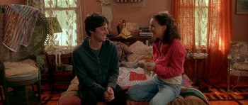 Movie still from “Garden State” (2004), directed by Zach Braff – A man and a woman sitting on a bed together; Medium shot, Over the shoulder angle