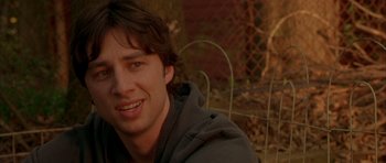 Movie still from “Garden State” (2004), directed by Zach Braff – A person smiling for a picture; Close Up shot, Over the shoulder angle