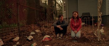 Movie still from “Garden State” (2004), directed by Zach Braff – A man and a woman sitting on the ground in the dirt; Wide shot, Low angle