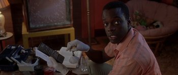 Movie still from “Garden State” (2004), directed by Zach Braff – A man holding a cell phone in his hand; Close Up shot, Low angle