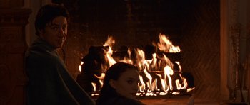 Movie still from “Garden State” (2004), directed by Zach Braff – A woman sitting in front of a fire place; Close Up shot, Over the shoulder angle
