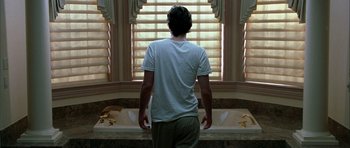 Movie still from “Garden State” (2004), directed by Zach Braff – A man standing in front of a bath tub in a bathroom; Medium shot, Low angle