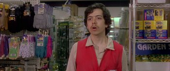 Movie still from “Garden State” (2004), directed by Zach Braff – A man in a red vest standing in a store; Close Up shot, Low angle
