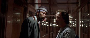 Movie still from “Garden State” (2004), directed by Zach Braff – A man in a hat and a man in a suit talking to each other; Close Up shot, Low angle