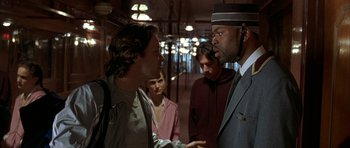 Movie still from “Garden State” (2004), directed by Zach Braff – A group of men standing around each other in a room; Close Up shot, Low angle