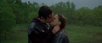 Movie still from “Garden State” (2004), directed by Zach Braff – A man and a woman kissing each other in the rain; Medium shot, Low angle