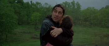 Movie still from “Garden State” (2004), directed by Zach Braff – A man hugging another man in the rain; Close Up shot, Low angle