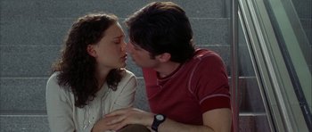 Movie still from “Garden State” (2004), directed by Zach Braff – A man and a woman are kissing on the cheek; Medium shot, Overhead angle
