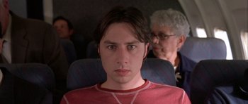 Movie still from “Garden State” (2004), directed by Zach Braff – A young man sitting on a seat in front of an older woman; Close Up shot, High angle