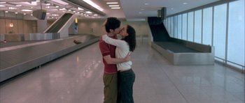 Movie still from “Garden State” (2004), directed by Zach Braff – A man and a woman kissing in an airport terminal; Wide shot, High angle