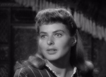 Movie still from “Gaslight” (1944), directed by George Cukor – A black - and - white photo of a woman in a striped shirt; Close Up shot, Over the shoulder angle