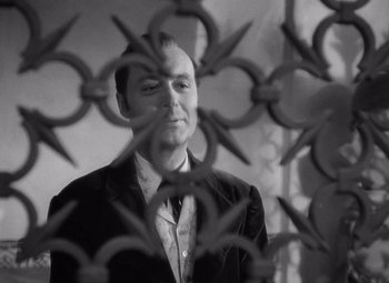 Movie still from “Gaslight” (1944), directed by George Cukor – A black and white photo of a man in a suit; Close Up shot, Over the shoulder angle