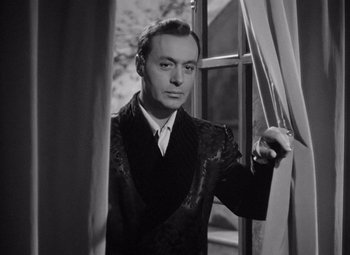 Movie still from “Gaslight” (1944), directed by George Cukor – A man standing in front of a window; Close Up shot, Low angle
