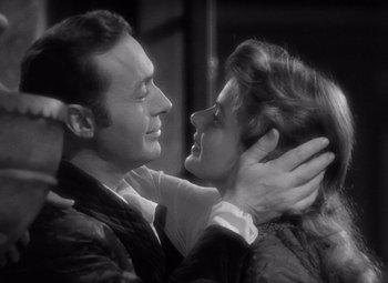 Movie still from “Gaslight” (1944), directed by George Cukor – A man and a woman embracing each other in a black and white photo; Close Up shot, High angle