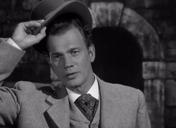 Movie still from “Gaslight” (1944), directed by George Cukor – A black and white photo of a man wearing a hat; Close Up shot, Low angle