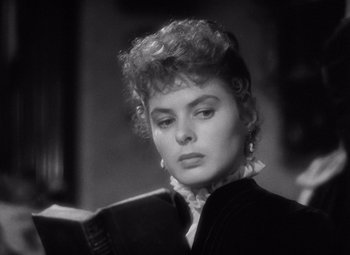Movie still from “Gaslight” (1944), directed by George Cukor – A black - and - white photo of a woman reading a book; Close Up shot, Over the shoulder angle