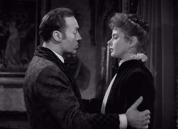 Movie still from “Gaslight” (1944), directed by George Cukor – A man and a woman embracing each other in a black and white photo; Medium shot, High angle
