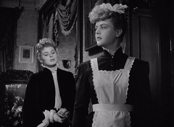 Movie still from “Gaslight” (1944), directed by George Cukor – Two women dressed up in old fashion clothing; Medium shot, Low angle