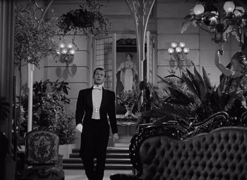 Movie still from “Gaslight” (1944), directed by George Cukor – A man in a tuxedo walking down a hall way; Wide shot, Low angle