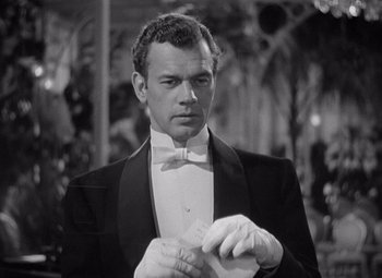 Movie still from “Gaslight” (1944), directed by George Cukor – A black and white photo of a man in a tuxedo; Close Up shot, Over the shoulder angle