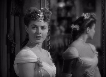 Movie still from “Gaslight” (1944), directed by George Cukor – A black and white photo of a woman in a dress; Close Up shot, Over the shoulder angle