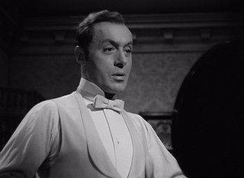 Movie still from “Gaslight” (1944), directed by George Cukor – A man wearing a white shirt and a bow tie; Close Up shot, Low angle