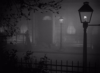 Movie still from “Gaslight” (1944), directed by George Cukor – A black and white photo of a foggy night; Wide shot, High angle