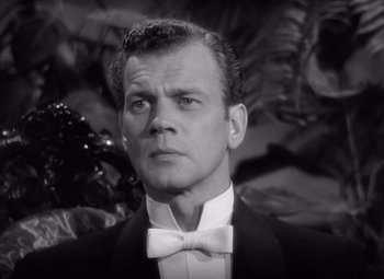 Movie still from “Gaslight” (1944), directed by George Cukor – A man wearing a suit and a bow tie; Close Up shot, Low angle