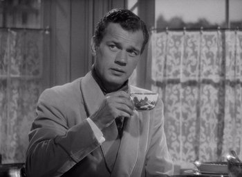 Movie still from “Gaslight” (1944), directed by George Cukor – A black and white photo of a man drinking a cup of coffee; Close Up shot, High angle
