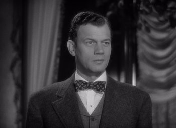 Movie still from “Gaslight” (1944), directed by George Cukor – A man wearing a suit and a bow tie; Close Up shot, Low angle