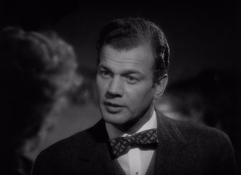 Movie still from “Gaslight” (1944), directed by George Cukor – A man wearing a suit and a bow tie; Close Up shot, Over the shoulder angle