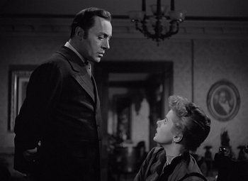 Movie still from “Gaslight” (1944), directed by George Cukor – A man and a woman are standing in front of each other; Medium shot, Low angle