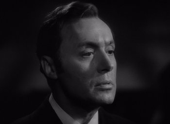 Movie still from “Gaslight” (1944), directed by George Cukor – Black and white photograph of a man in a business suit; Close Up shot, Low angle