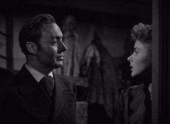 Movie still from “Gaslight” (1944), directed by George Cukor – A man and a woman standing next to each other; Close Up shot, Low angle