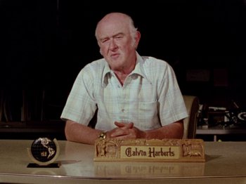 Movie still from “Gates of Heaven” (1978), directed by Errol Morris – An older man sitting at a desk in front of a clock; Close Up shot, Low angle