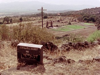 Movie still from “Gates of Heaven” (1978), directed by Errol Morris – An old radio sitting in the middle of a field; Extreme Wide shot, High angle