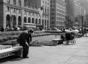 Movie still from “Gentleman's Agreement” (1947), directed by Elia Kazan – An older man sitting on a bench in a city; Wide shot, High angle