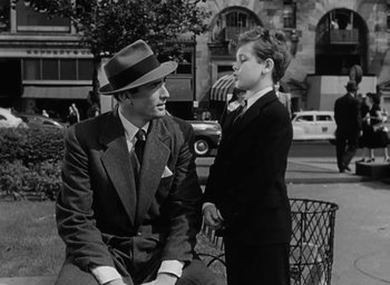 Movie still from “Gentleman's Agreement” (1947), directed by Elia Kazan – A man in a suit and a boy in a tie; Medium shot, Over the shoulder angle