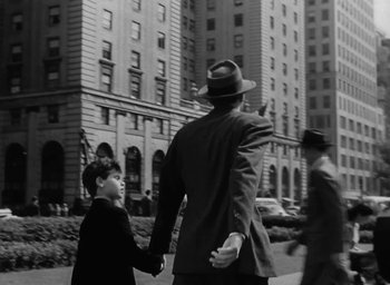 Movie still from “Gentleman's Agreement” (1947), directed by Elia Kazan – A man and a boy walking down a street; Wide shot, Over the shoulder angle