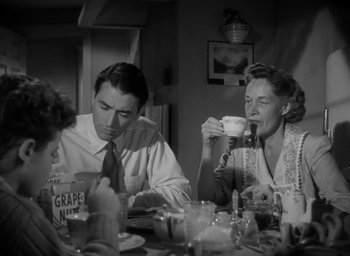 Movie still from “Gentleman's Agreement” (1947), directed by Elia Kazan – A man and a woman sitting at a dinner table; Medium shot, Low angle