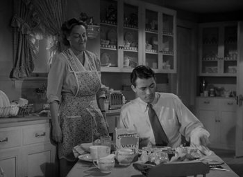 Movie still from “Gentleman's Agreement” (1947), directed by Elia Kazan – A man and a woman in the kitchen preparing a meal; Medium shot, High angle