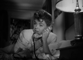 Movie still from “Gentleman's Agreement” (1947), directed by Elia Kazan – A black and white photo of a woman talking on a phone; Close Up shot, High angle