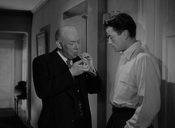 Movie still from “Gentleman's Agreement” (1947), directed by Elia Kazan – Two men standing next to each other in a room; Medium shot, Low angle