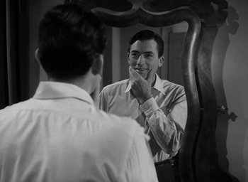 Movie still from “Gentleman's Agreement” (1947), directed by Elia Kazan – A man looking at himself in the mirror while brushing his teeth; Close Up shot, Over the shoulder angle