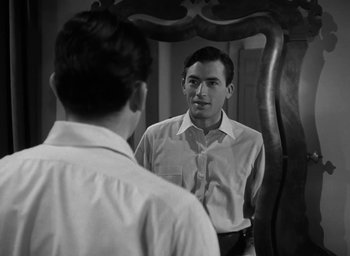 Movie still from “Gentleman's Agreement” (1947), directed by Elia Kazan – A young man looking at himself in the mirror; Medium shot, Over the shoulder angle