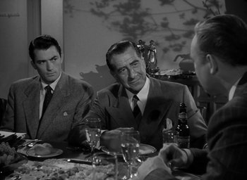Movie still from “Gentleman's Agreement” (1947), directed by Elia Kazan – A group of men sitting at a table with plates of food; Medium shot, Over the shoulder angle